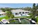 Beautiful waterfront home featuring a private dock, a plunge pool, and an outdoor living space perfect for entertaining at 670 Old Compass Rd, Longboat Key, FL 34228