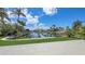 Picturesque waterfront view with lush landscaping, private docks, and canal at 670 Old Compass Rd, Longboat Key, FL 34228