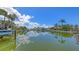 Picturesque waterfront property showcasing a private dock on a tranquil canal lined with lush landscaping at 670 Old Compass Rd, Longboat Key, FL 34228