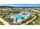 A beautiful aerial view showcasing the community pool, clubhouse, tennis courts and playground at 7352 Cabin Ln, Sarasota, FL 34240