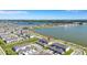 Stunning aerial view of townhomes in a community with lake and landscaped surroundings under a bright blue sky at 7352 Cabin Ln, Sarasota, FL 34240