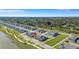 An aerial view showcases townhomes nestled within a community and adjacent to a serene lake at 7352 Cabin Ln, Sarasota, FL 34240