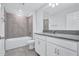Modern bathroom with a large mirror, dual sinks, and a tiled shower-tub combination at 7352 Cabin Ln, Sarasota, FL 34240