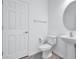 Elegant half bath features modern fixtures and a pedestal sink, offering a clean and stylish design at 7352 Cabin Ln, Sarasota, FL 34240