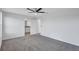 Bright bedroom with neutral carpet, a ceiling fan, and an ensuite bathroom at 7352 Cabin Ln, Sarasota, FL 34240