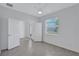 Bright bedroom featuring tile floors, a ceiling fan, an exterior view and double entry doors at 7352 Cabin Ln, Sarasota, FL 34240