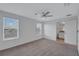 Well-lit bedroom featuring two windows, a ceiling fan, and an attached bathroom at 7352 Cabin Ln, Sarasota, FL 34240