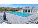 An inviting community pool with sun loungers surrounded by palm trees at 7352 Cabin Ln, Sarasota, FL 34240