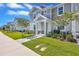 Inviting two-story townhome showcasing lush landscaping, a paved walkway, and a welcoming entryway at 7352 Cabin Ln, Sarasota, FL 34240