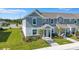 Charming two-story townhome features a covered entry, landscaped yard, and inviting curb appeal at 7352 Cabin Ln, Sarasota, FL 34240