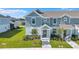 Charming two-story townhome features a covered entry, landscaped yard, and inviting curb appeal at 7352 Cabin Ln, Sarasota, FL 34240