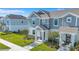 Charming two-story townhome features a covered entry, landscaped yard, and inviting curb appeal at 7352 Cabin Ln, Sarasota, FL 34240