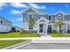 Charming two-story home featuring a well-maintained front yard, beautiful landscaping, and a welcoming entryway at 7352 Cabin Ln, Sarasota, FL 34240