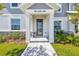 Inviting entryway with covered porch and decorative stone accents, leading to a modern front door at 7352 Cabin Ln, Sarasota, FL 34240