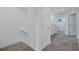 Well-lit hallway with neutral tones, carpeted floors, and access to multiple rooms, enhancing flow at 7352 Cabin Ln, Sarasota, FL 34240