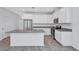 Modern kitchen with white cabinets, stainless steel appliances, and an island perfect for food preparation at 7352 Cabin Ln, Sarasota, FL 34240