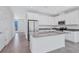 Bright and modern kitchen featuring stainless steel appliances, a large island, and ample cabinet space at 7352 Cabin Ln, Sarasota, FL 34240