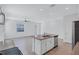 Open-concept kitchen with a large island and stainless steel appliances, creating a modern and functional space at 7352 Cabin Ln, Sarasota, FL 34240