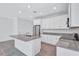 Stylish kitchen featuring an island with sink, stainless steel appliances, and modern white cabinetry at 7352 Cabin Ln, Sarasota, FL 34240