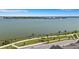 A scenic aerial view showing a wide lakefront bordered by walking paths and landscaping at 7352 Cabin Ln, Sarasota, FL 34240