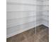 Spacious walk-in pantry offering ample storage with wire shelving and tiled floor at 7352 Cabin Ln, Sarasota, FL 34240