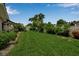Lush backyard featuring a well-manicured lawn, mature trees, and attractive landscaping at 7404 14Th W Ave, Bradenton, FL 34209