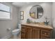 The bathroom features a granite countertop, decorative fixtures, framed mirror, and round mirror over a stylish vanity at 7404 14Th W Ave, Bradenton, FL 34209