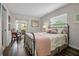 The bedroom features a stylish bed frame, comfortable seating, and a serene view of the outdoors through patio doors at 7404 14Th W Ave, Bradenton, FL 34209
