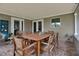 Inviting covered patio with a brick floor and comfortable wooden outdoor furniture at 7404 14Th W Ave, Bradenton, FL 34209