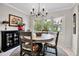 Cozy dining area featuring a circular table, decorative lighting, and a sunlit bay window at 7404 14Th W Ave, Bradenton, FL 34209
