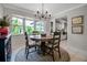 Bright dining area featuring a round table, bay window, and elegant chandelier at 7404 14Th W Ave, Bradenton, FL 34209