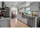 Modern kitchen with stainless steel appliances, white cabinets, and a view into the dining area at 7404 14Th W Ave, Bradenton, FL 34209