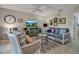 Comfortable living room features stylish furniture, decor, and a ceiling fan, creating a welcoming atmosphere at 7404 14Th W Ave, Bradenton, FL 34209