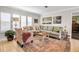 Comfortable living room with a patterned accent chair, neutral sofa, and decorative rug at 7404 14Th W Ave, Bradenton, FL 34209