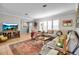 Inviting living room featuring a sectional sofa, patterned chair, and stylish decor accents at 7404 14Th W Ave, Bradenton, FL 34209