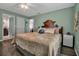 This is a cozy bedroom featuring a unique headboard, ceiling fan, and stylish decorative pillows, creating a restful retreat at 7404 14Th W Ave, Bradenton, FL 34209