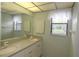 Bathroom featuring a double vanity, neutral countertop, and a large mirror at 753 Tropical Cir, Sarasota, FL 34242