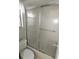 Cozy bathroom with a toilet and a textured glass shower door at 753 Tropical Cir, Sarasota, FL 34242