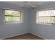 Serene bedroom with large windows offering natural light and privacy blinds at 753 Tropical Cir, Sarasota, FL 34242