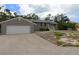 Charming single-story home featuring an attached garage and well-maintained landscaping at 753 Tropical Cir, Sarasota, FL 34242