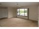 Bright living room with a ceiling fan and large window overlooking the front yard at 753 Tropical Cir, Sarasota, FL 34242