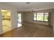 Open-concept living room with a view of the kitchen and access to the outdoor deck at 753 Tropical Cir, Sarasota, FL 34242