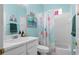 Colorful bathroom with white vanity, decorative flamingo art, and a shower with a curtain at 7747 33Rd E St, Sarasota, FL 34243