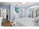 Light-filled bedroom featuring hardwood floors, ocean artwork and a decorative chandelier at 7747 33Rd E St, Sarasota, FL 34243