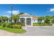 Community clubhouse featuring well-maintained landscaping and a dedicated parking space at 7747 33Rd E St, Sarasota, FL 34243