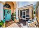 Inviting front patio with a light blue door, outdoor seating, grill, and stylish decor, creating a relaxing space at 7747 33Rd E St, Sarasota, FL 34243