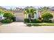 Charming single-story home with beautiful landscaping and a brick paver driveway, providing curb appeal at 7747 33Rd E St, Sarasota, FL 34243