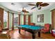 Spacious game room with a pool table, ceiling fans, and large windows with window coverings at 7747 33Rd E St, Sarasota, FL 34243
