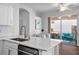 Open kitchen with white cabinets, stainless steel appliances, and a view of the screened-in porch at 7747 33Rd E St, Sarasota, FL 34243