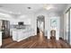 Bright kitchen featuring white cabinets, stainless steel appliances, hardwood floors, and an open layout at 7747 33Rd E St, Sarasota, FL 34243